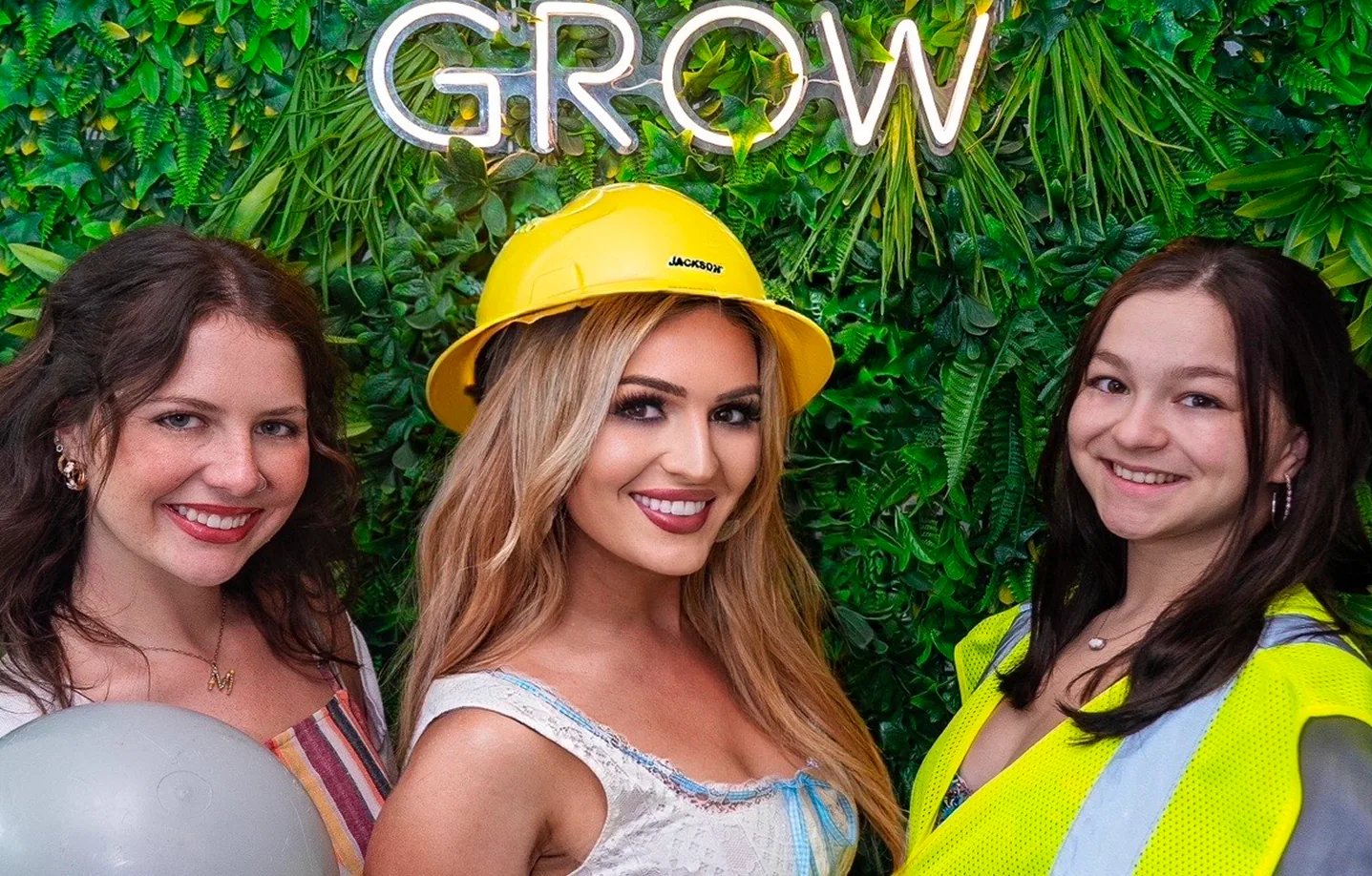 GROW neon sign with team